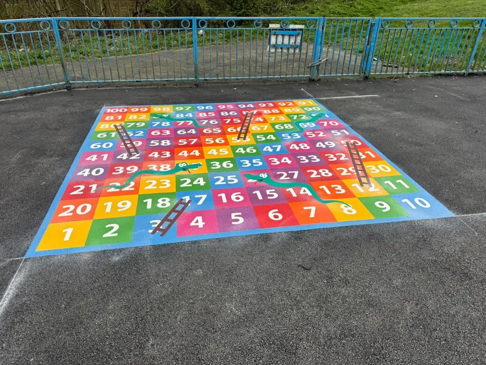 1 to 100 Snakes and Ladders thermoplastic playground marking at a UK school