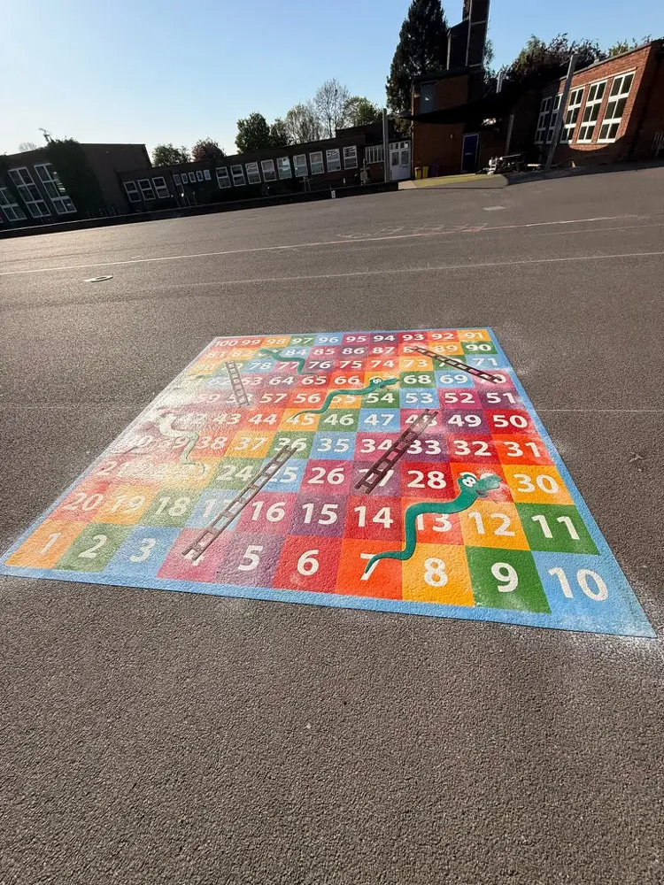 1 to 100 Snakes and Ladders thermoplastic playground marking at a UK school