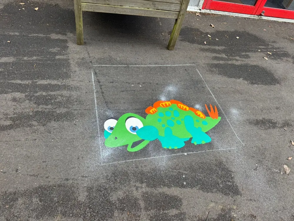 Dinosaur thermoplastic playground marking at a UK school