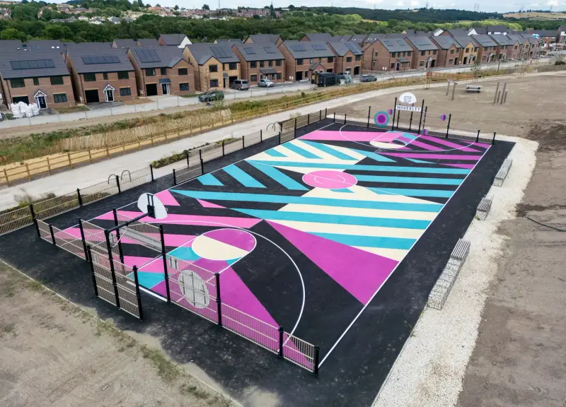 A multi-use games area with netball and basketball court markings