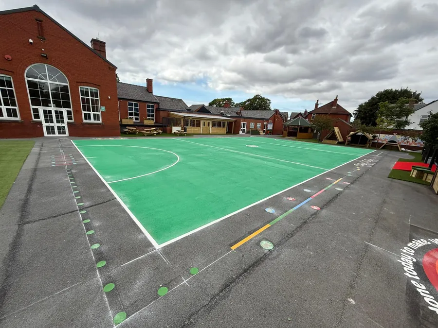 Uniplay's own team heat-bonding thermoplastic court markings on a school playground
