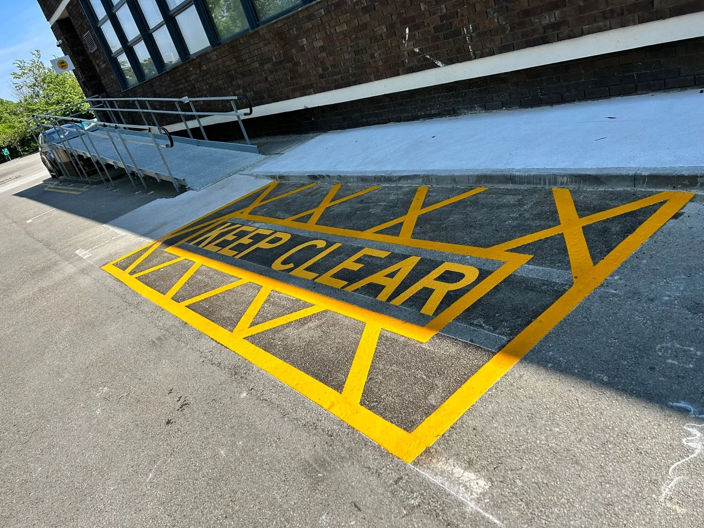Fresh white car park bay lines laid on tarmac