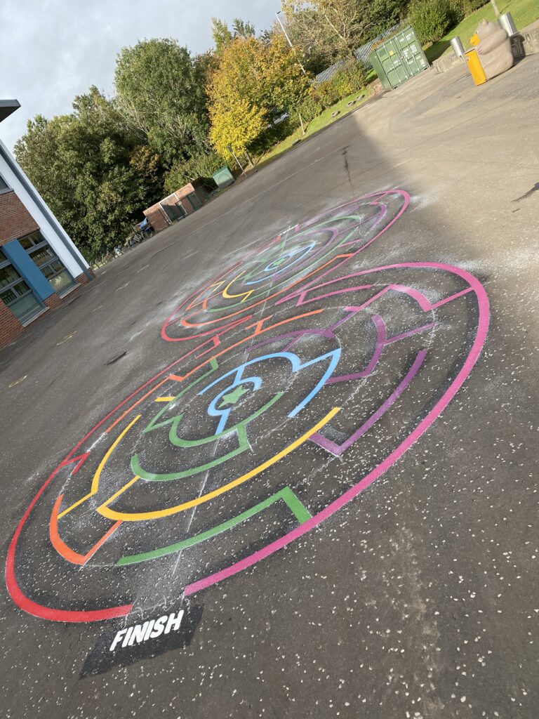 Painted maze playground marking on a school tarmac surface