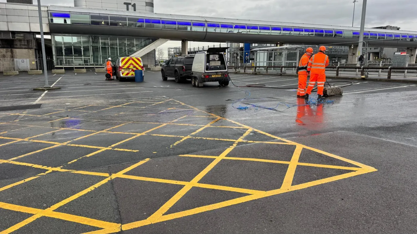 A tarmac surface cleared by controlled removal, without the charring or blackening that burning off leaves behind