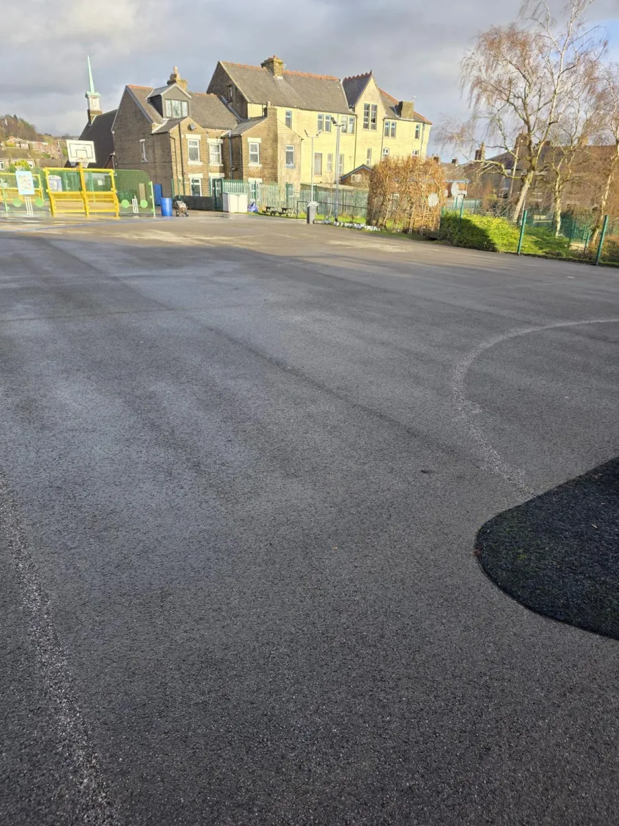 Close view of specialist water blasting lifting surface markings from tarmac