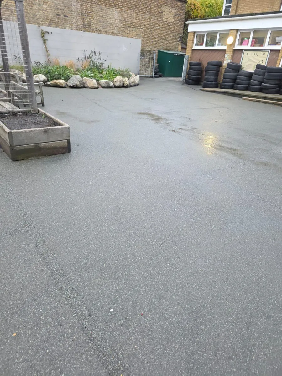 A Uniplay operative in hi-vis removing markings from a hard surface with specialist equipment
