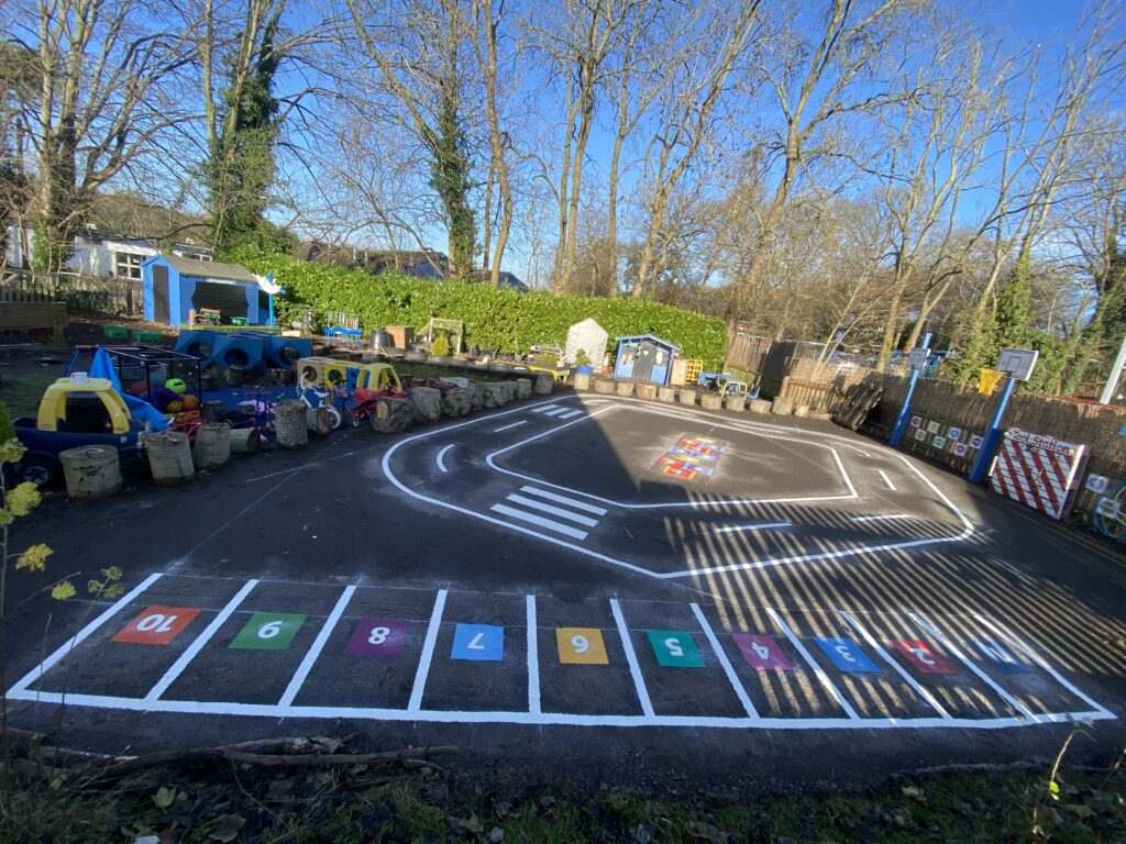Mini roadway with junctions and crossings for road-safety lessons in a playground