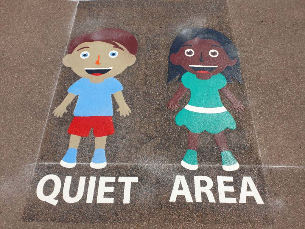 Calming sensory quiet-area markings with a winding trail on a school playground