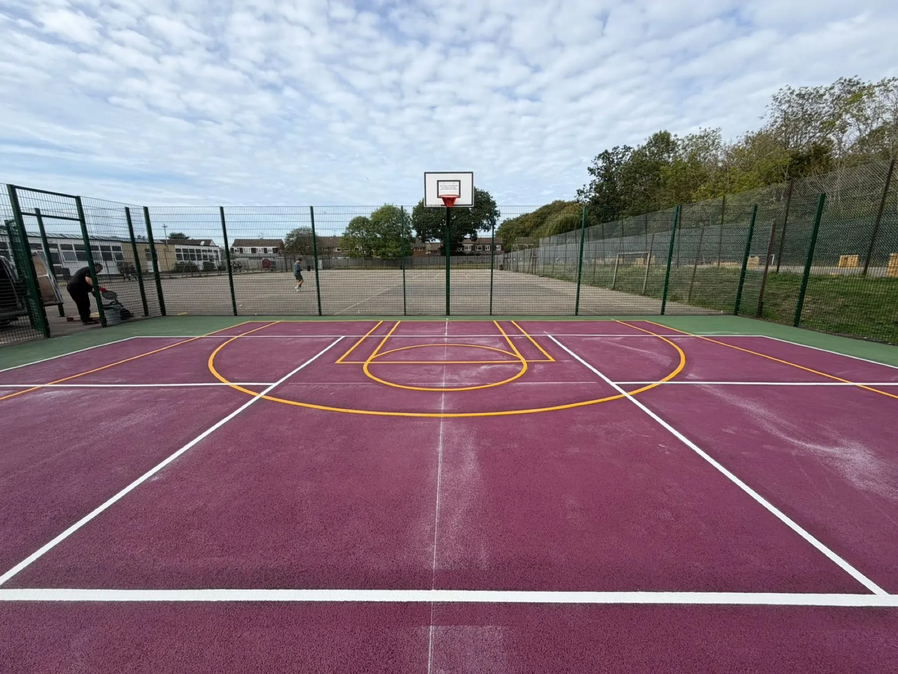 Basketball and netball lines on a bright purple sports court surface